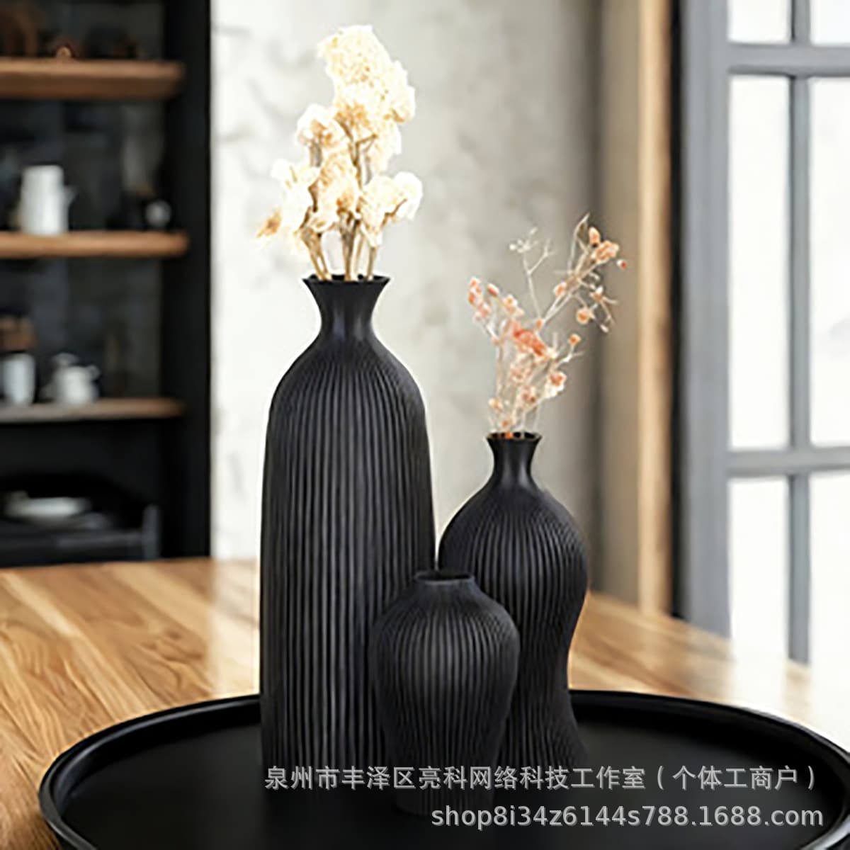 A set of vertical striped art vases, a modern minimalist home décor, suitable for dried flower arrangements.