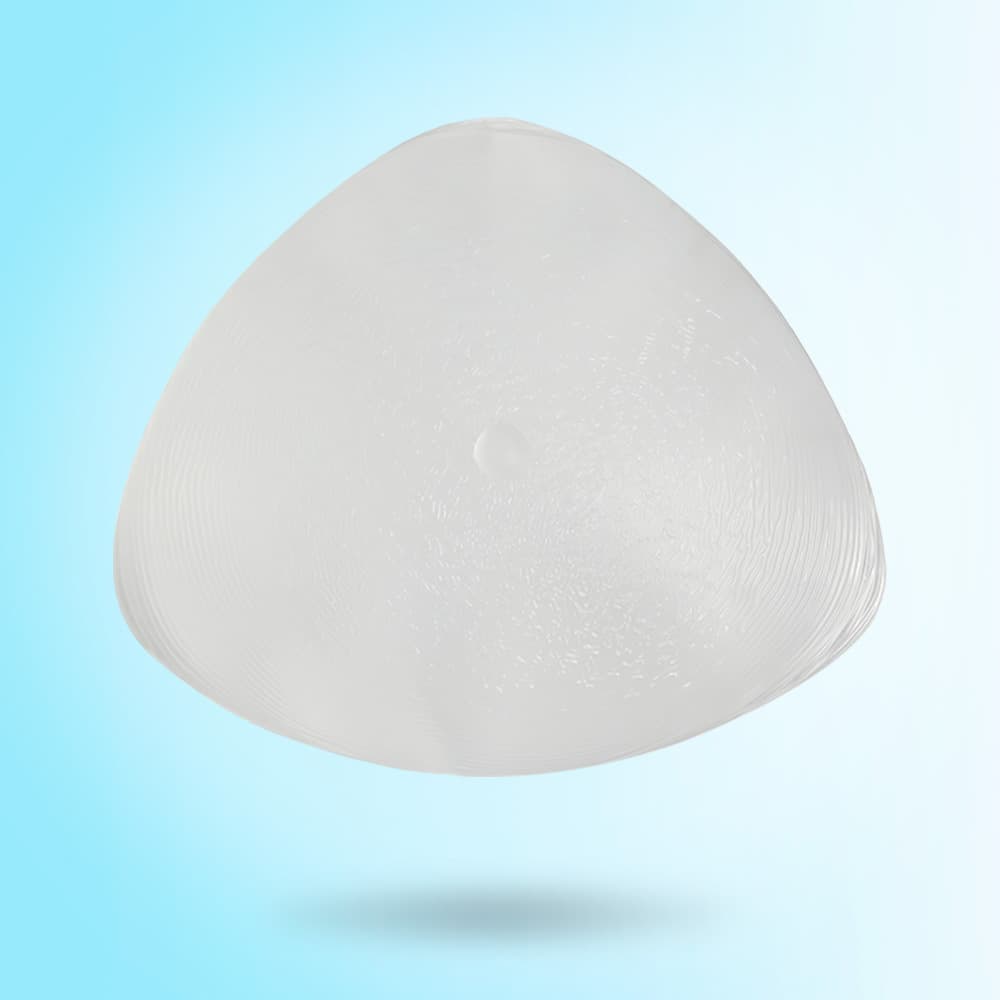 Brown head, concave bottom, triangular silicone post-operative breast prosthesis, wearing a dark skin-colored artificial breast after breast surgery.