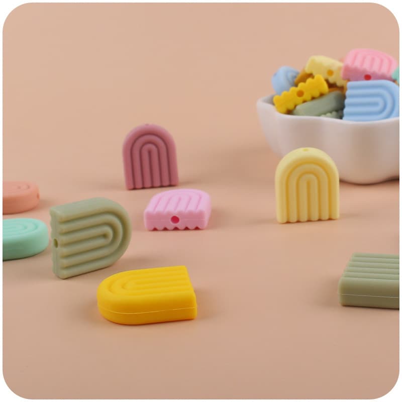 Creative DIY baby products cartoon silicone solid color rainbow tooth glue baby molars nipple anti-chain small accessories