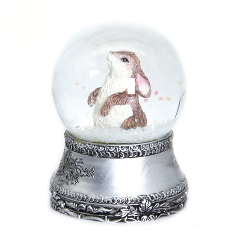 Cartoon creative animal rabbit snow globe with snowflake and eight-note music box, custom-made decorative ornament from Quanzhou manufacturer based on provided designs.