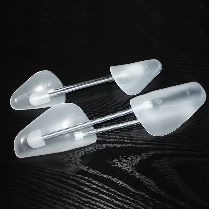 Spring shoe trees, adjustable plastic shoe trees, shoe stretchers for shaping and maintaining shoe width and toe shape.