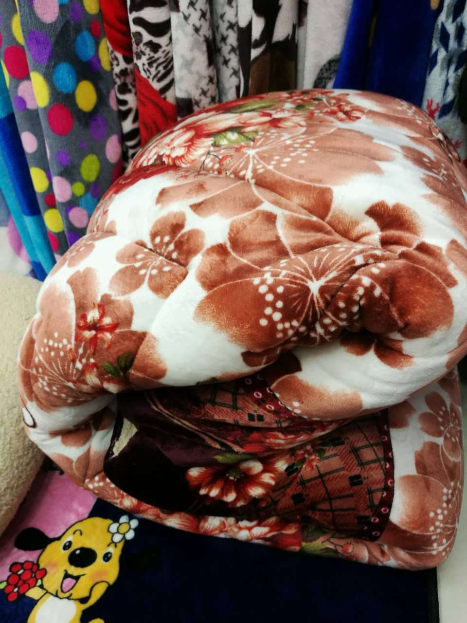Year-round supply of lamb fleece, flannel quilts, and various quilted composite quilts.