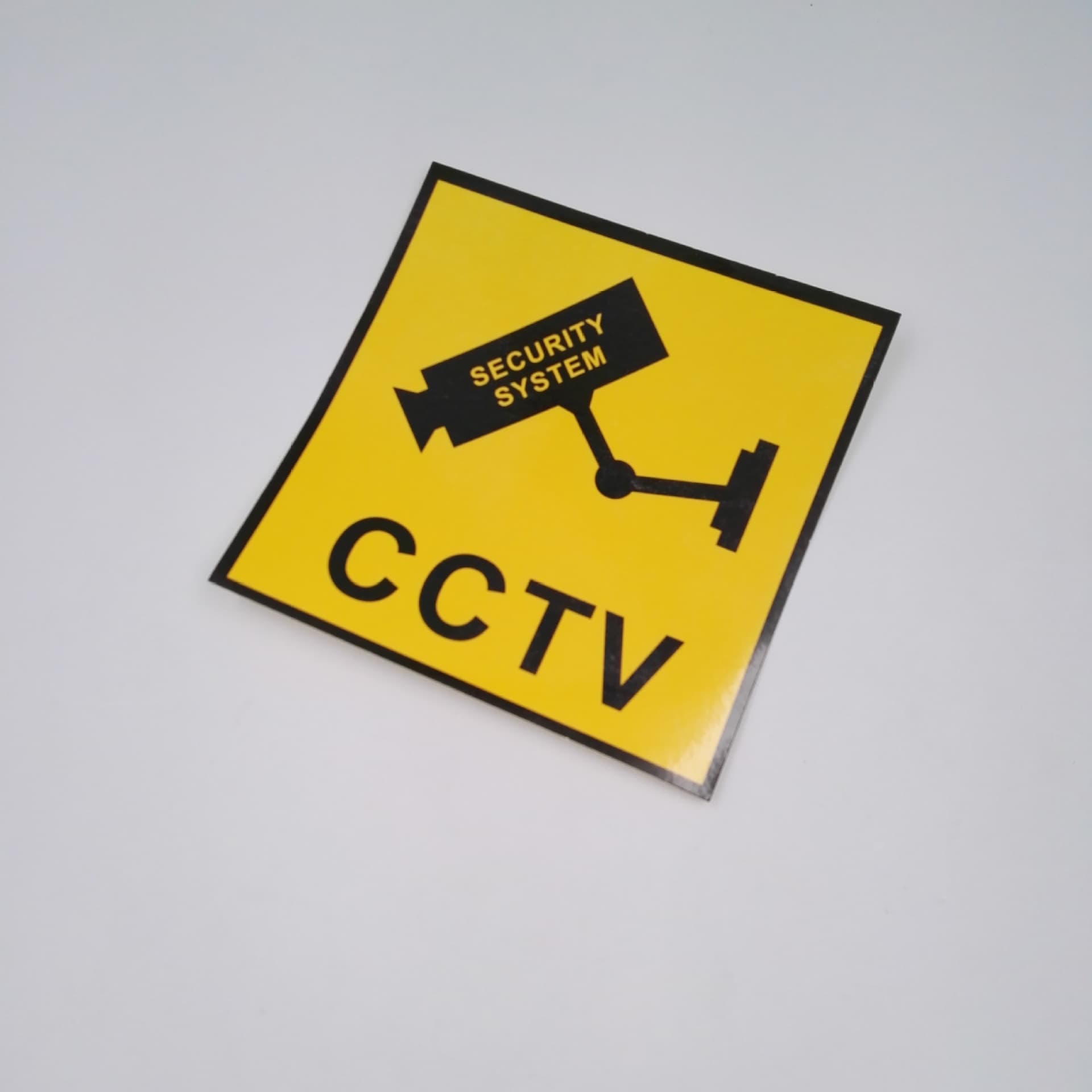 Warning sticker containing CCTV surveillance footage.