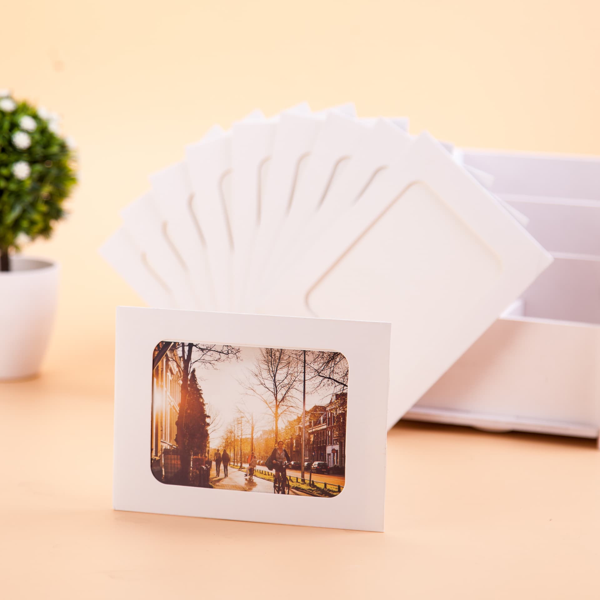 Creative hanging paper photo frames, logo options in single or multiple colors, custom designs and sizes accepted.