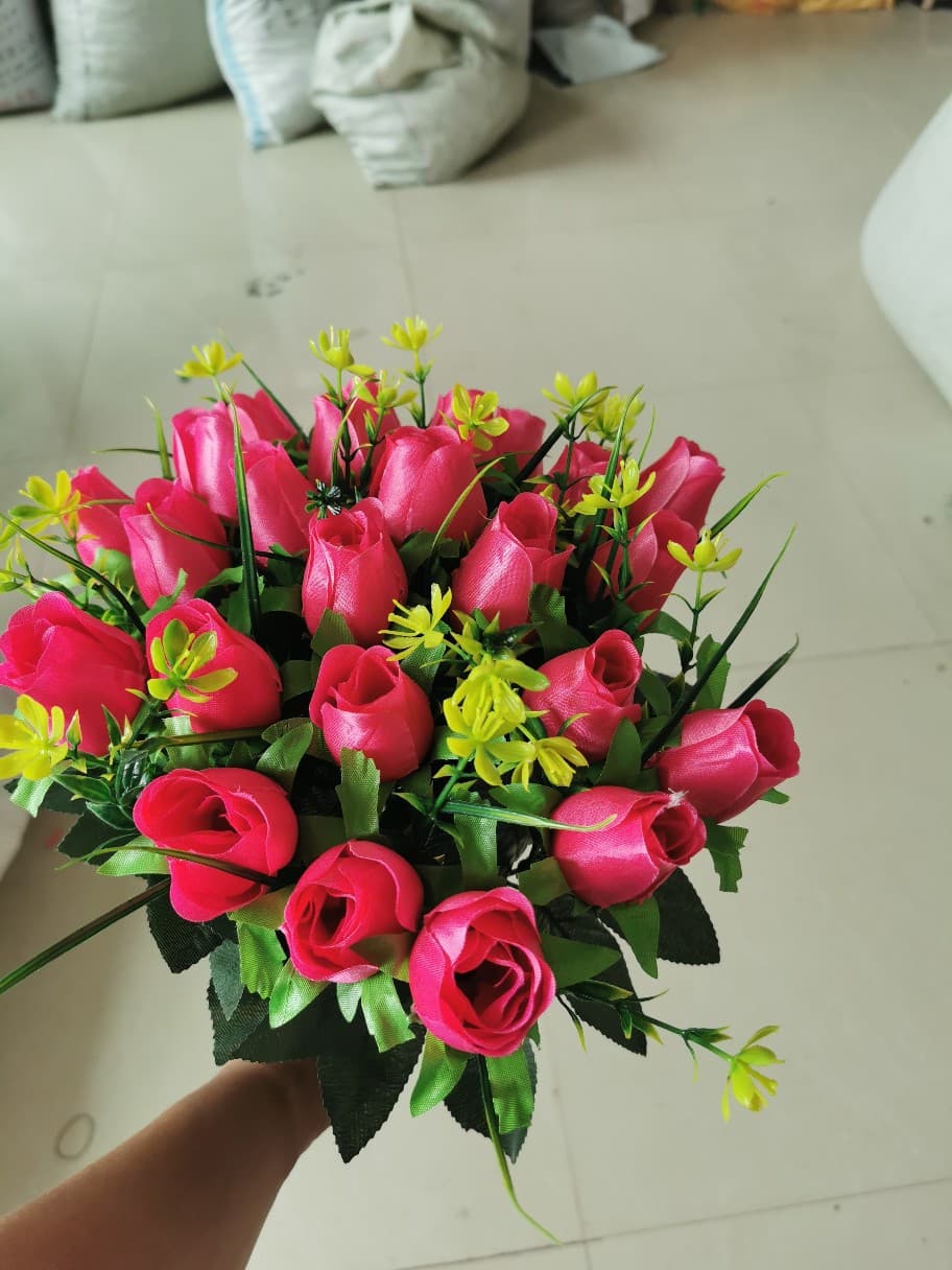 24 artificial roses held in hand, perfect for indoor home decor.