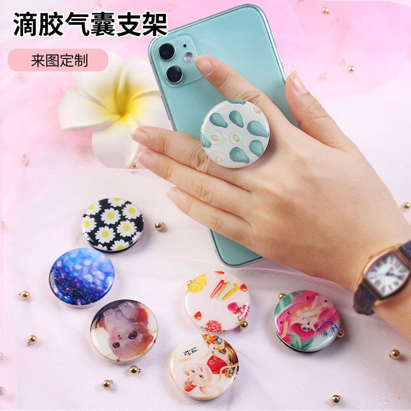 Factory wholesale mobile phone airbag holders, cartoon DIY anime epoxy UV color printing patterns, lazy folding holders.