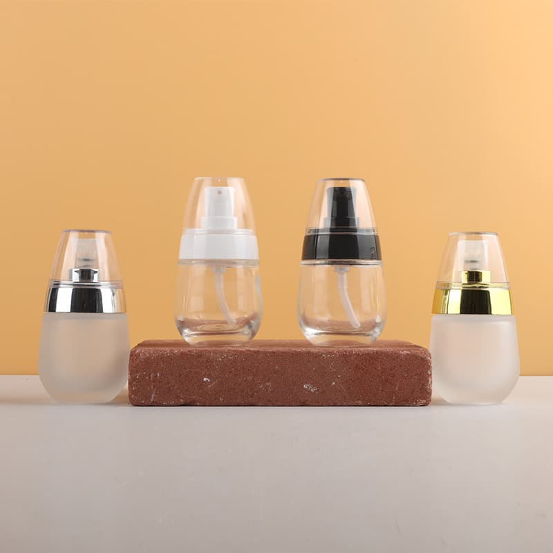 Wholesale of 30ml small travel refillable lotion bottles with glass pump heads for egg foundation bottles