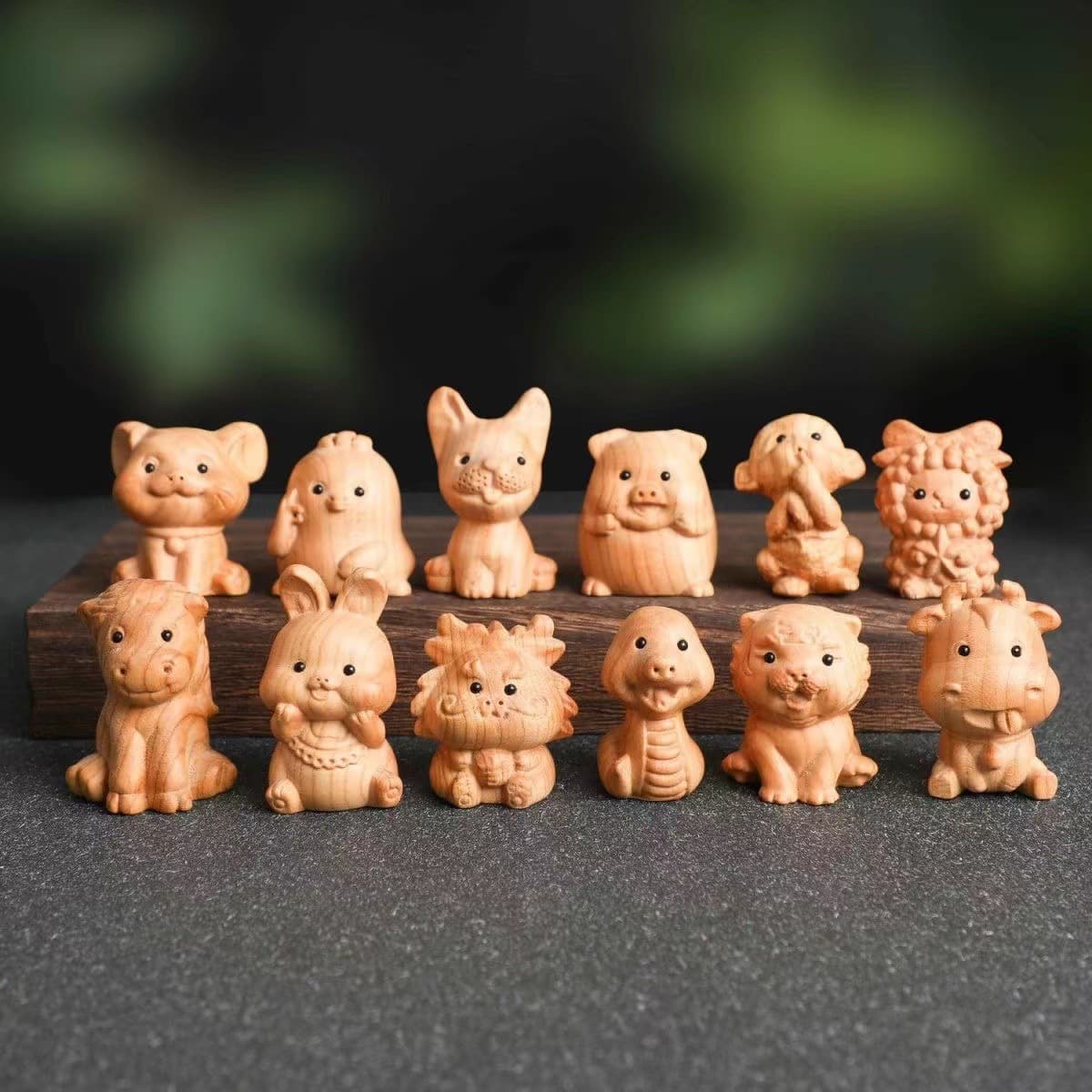 Cute peach wood carvings of the twelve zodiac animals: Rat, Ox, Tiger, Rabbit, Dragon, Snake, Horse, Sheep, Monkey, Rooster, Pig, and Dog.