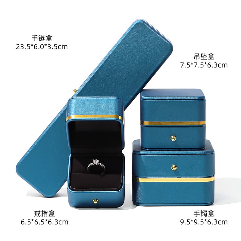 Rounded corner PU leather jewelry box with gold trim for rings, necklaces, pendants, earrings, bracelets, and gift packaging.