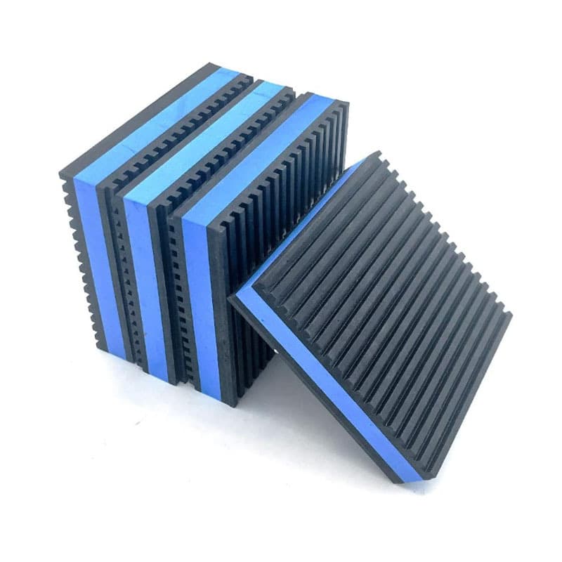 Heavy-duty equipment ribbed rubber shock absorption pad 4"x4"x7/8" with blue foam center isolation pad.