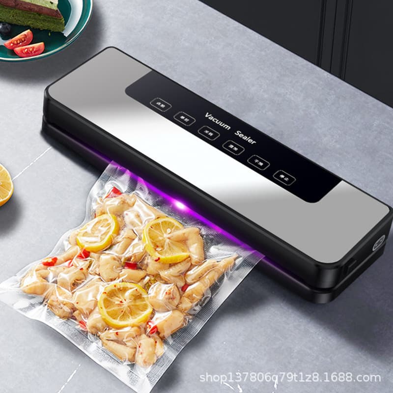 Fully automatic small vacuum kitchen food sealing and preservation packaging machine for home use.