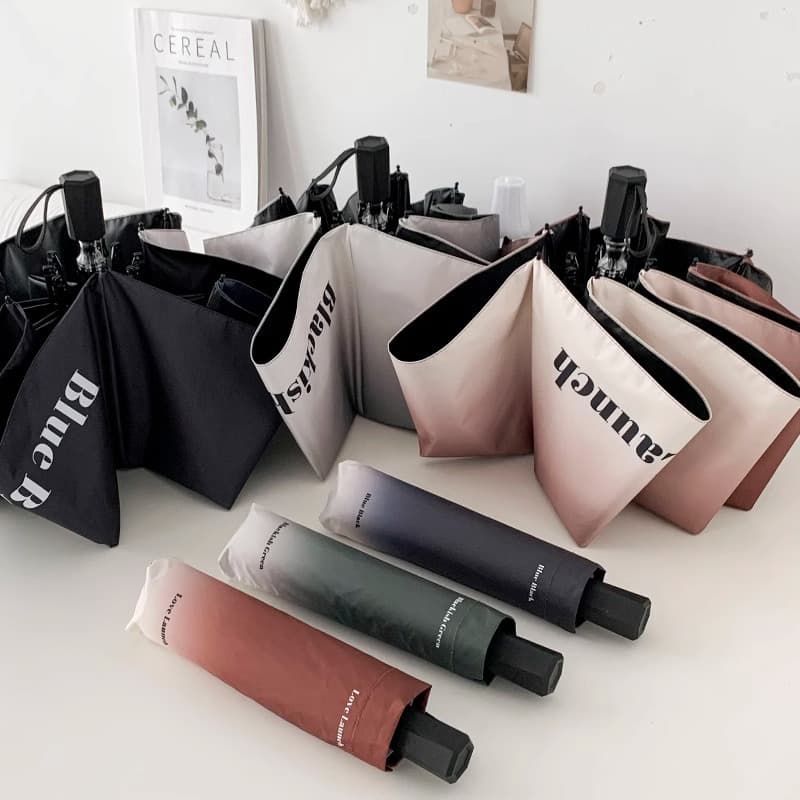 Custom logo umbrella for women, automatic foldable sun umbrella for sunny and rainy days, compact black rubber sun protection and UV blocking shade.
