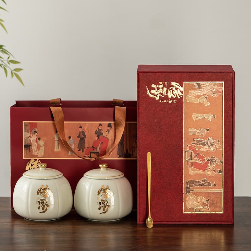 Heritage ceramic tea caddies and earthenware jars for black, green, and white tea, sealed and moisture-proof, packaged as festive gifts.