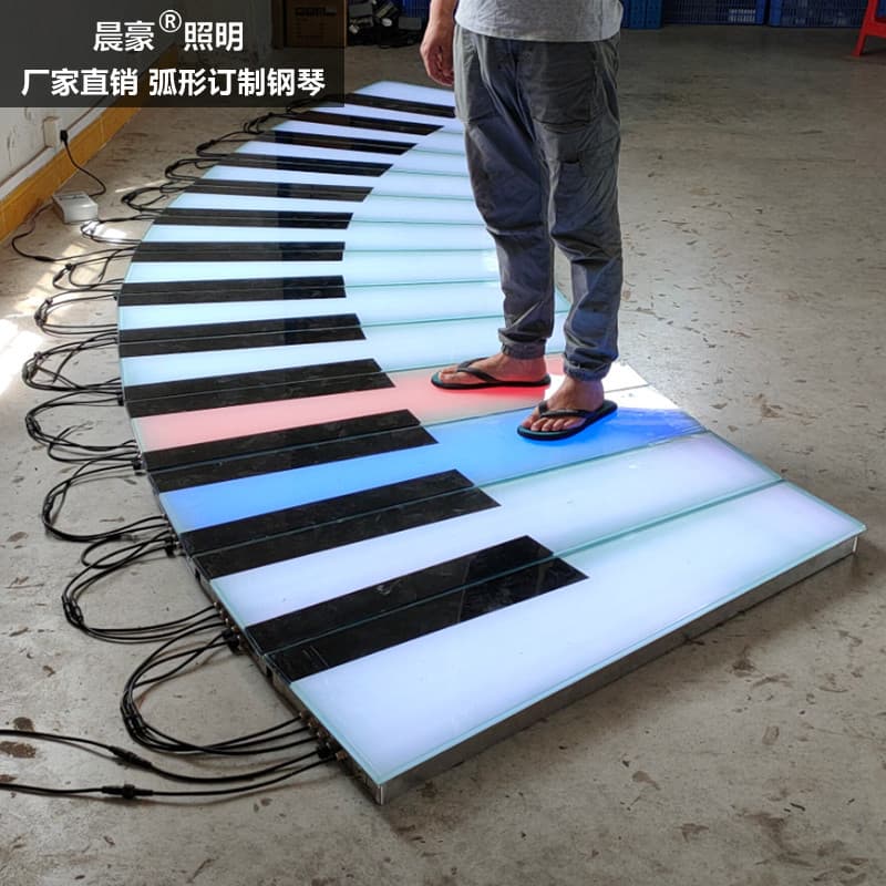 LED piano-themed floor tile light with gravity-activated human body movement, seven-color illumination, and sound generation, playing music as you step on the floor.