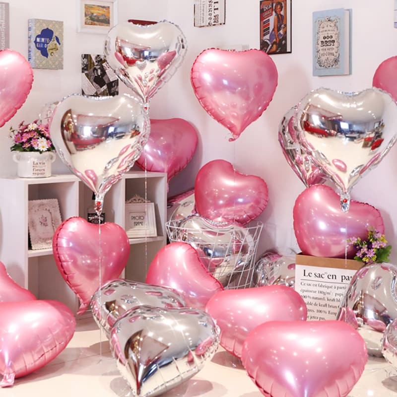 Pink aluminum foil balloons floating in the air, perfect for engagement room decorations, wedding stars, birthday heart-shaped decorations, and peach heart shapes.