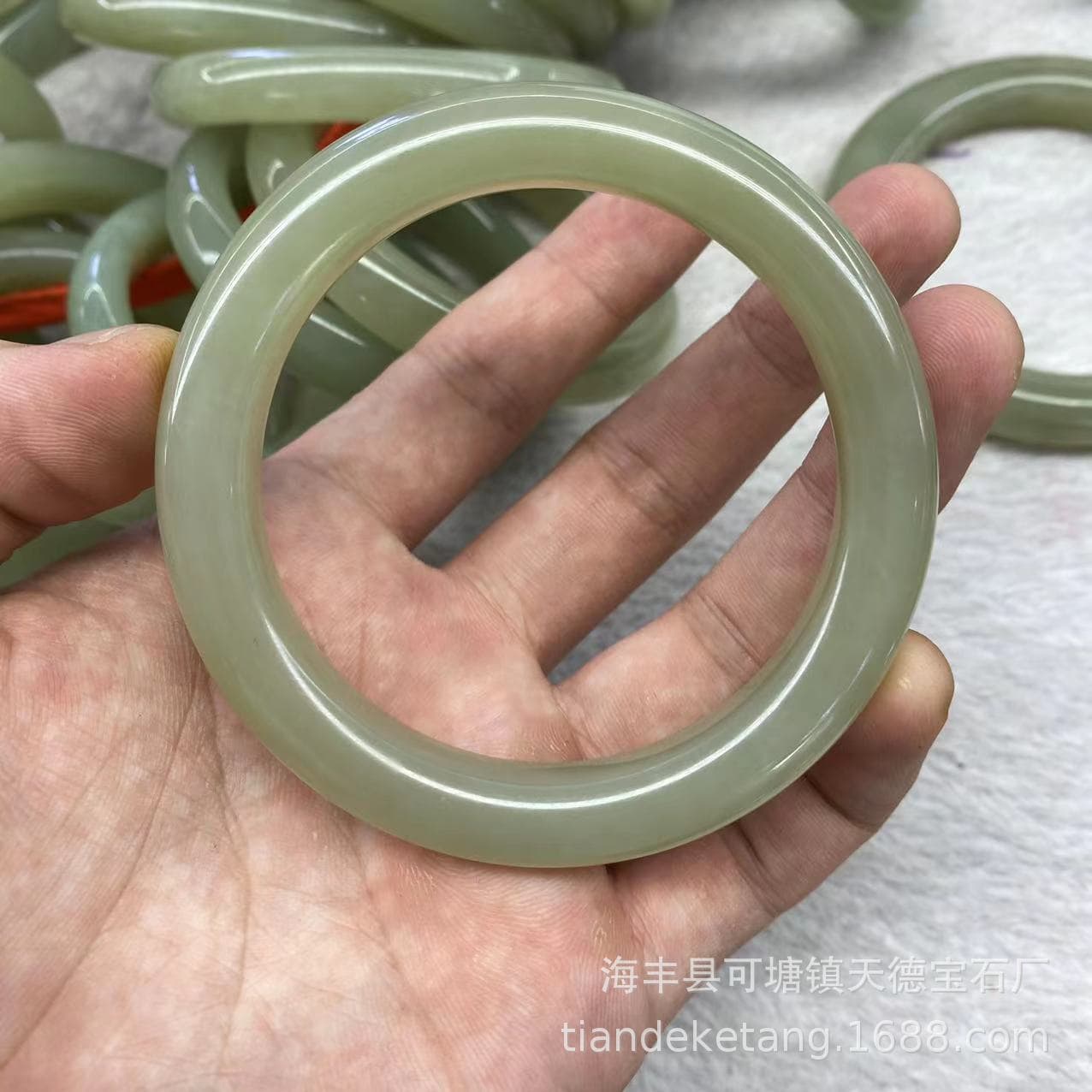 Natural Hetian Jade Harumi Bracelet. The jade quality is delicate, clean and free of cracks. The clear water color and slightly white cotton batting are of good quality. A+