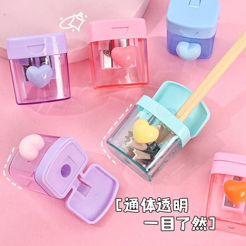 Macaron Color Cartoon Pencil Sharpener for Elementary Students, Four-Color Heart-Shaped Rotating Dual-Hole Sharpener, Transparent with Lid