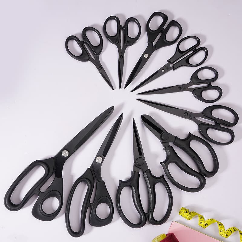 Large, blackened, household multi-functional hand scissors for tailoring fabric cutting and clothing. (The text also mentions rubber and plastic handles, but this seems unrelated to the main topic and is likely a separate, incomplete thought.)