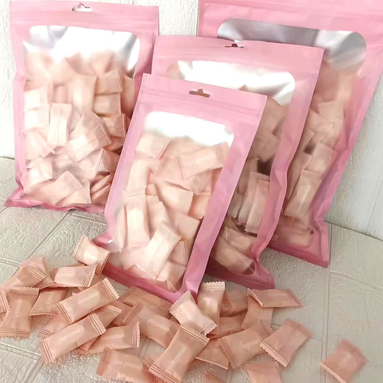 Disposable compressed towels with English packaging, pure cotton for travel and business trips, portable bagged compressed facial cleansing beauty towels.