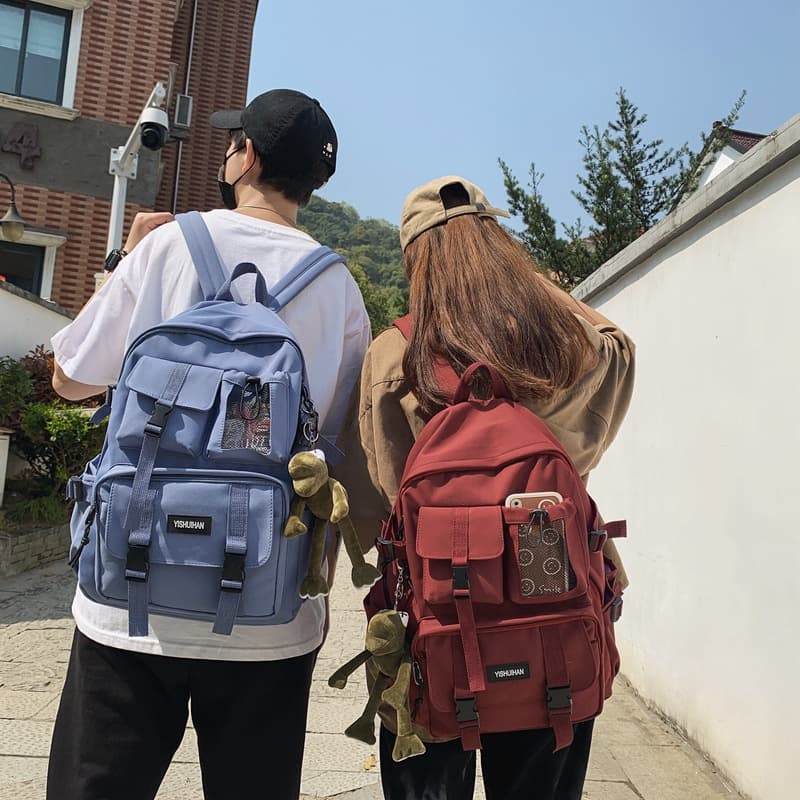 Casual and versatile unisex backpack with cute charm, trendy style, large capacity, and utility design for students