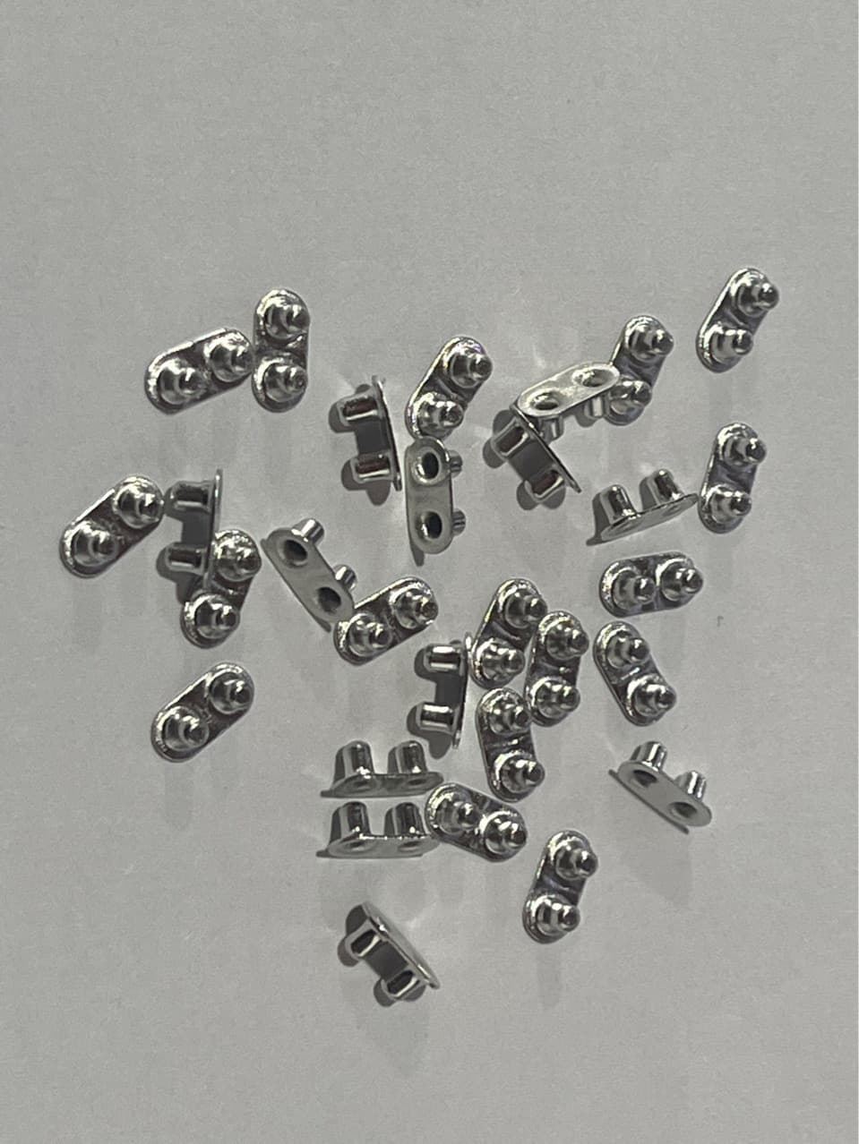 Double-hole rivet for automotive rearview mirror heating element, electronic components