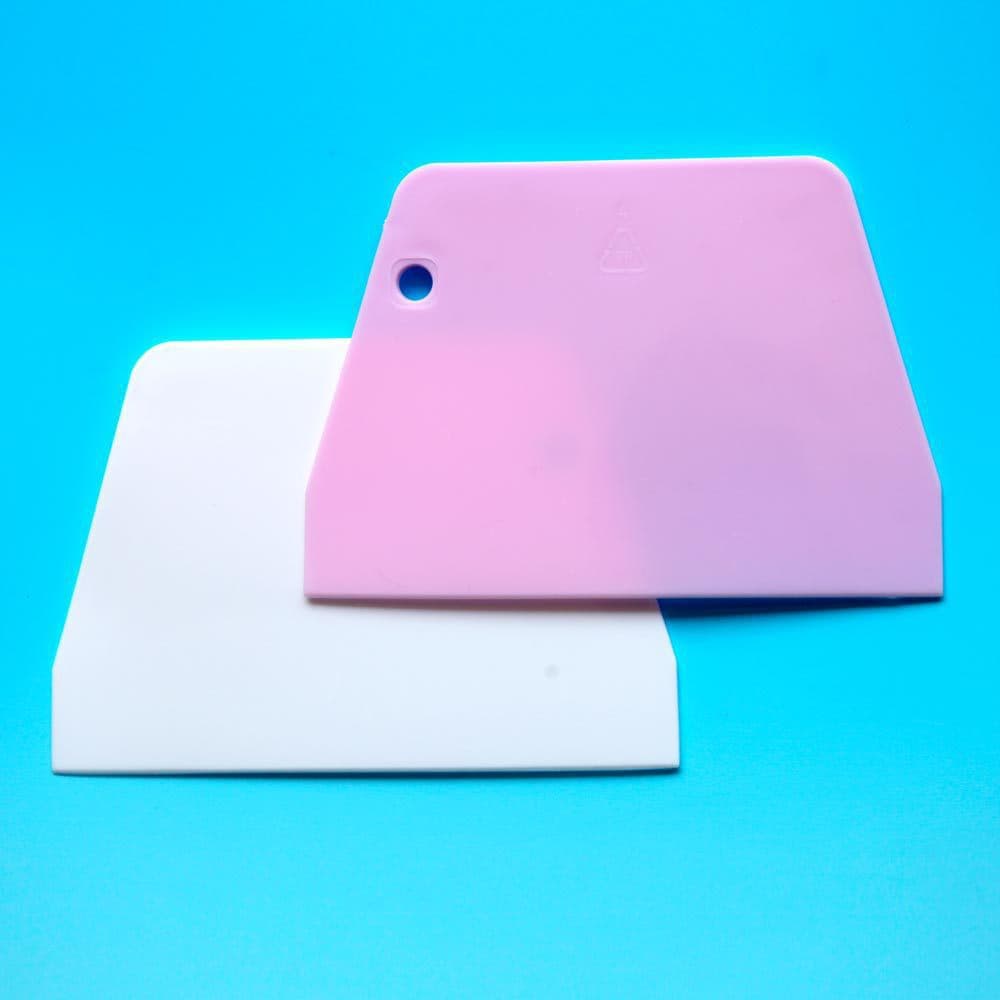 Plastic scraper for cutting and scraping car window tinting, glass, wallpaper, and other automotive supplies.