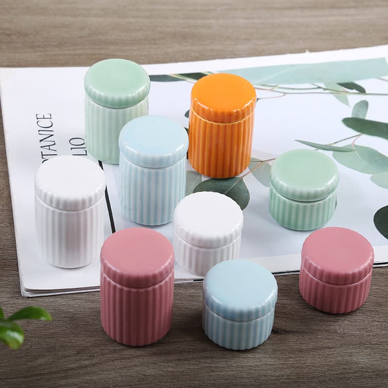 Mini ceramic powder jars with striped designs, traditional-style small porcelain containers for incense, portable tea caddies, celadon jars, and pill bottles.