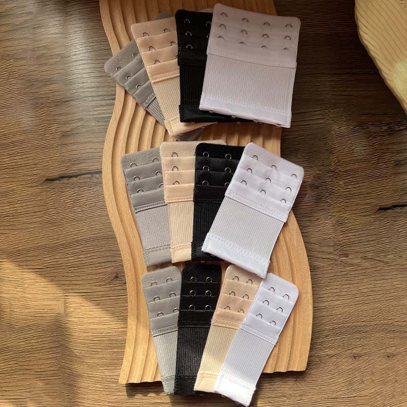 Elastic bra with extended hook-and-eye closure, four-row and three-row double hook-and-eye closures, three-hook back straps, and widened design.