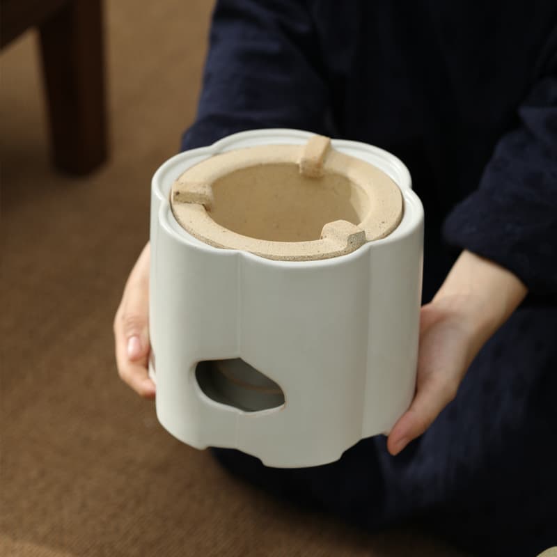 Indoor home tea brewing set with tea maker, Gongfu teapot, ceramic alcohol lamp, and charcoal stove base.