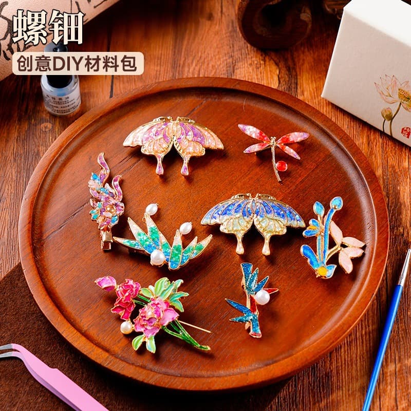 Mother-of-pearl DIY material kit for children's handmade brooches, including butterfly and moth designs, abalone and shell fragments, and a trendy imitation kingfisher feather hairpin.