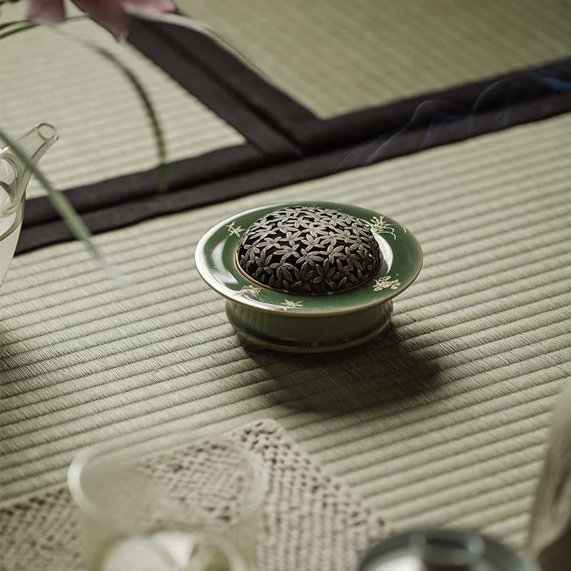 Yue ware plum-green porcelain incense burner with copper lid, a creative indoor incense coil, sandalwood incense stick holder, and incense charm.