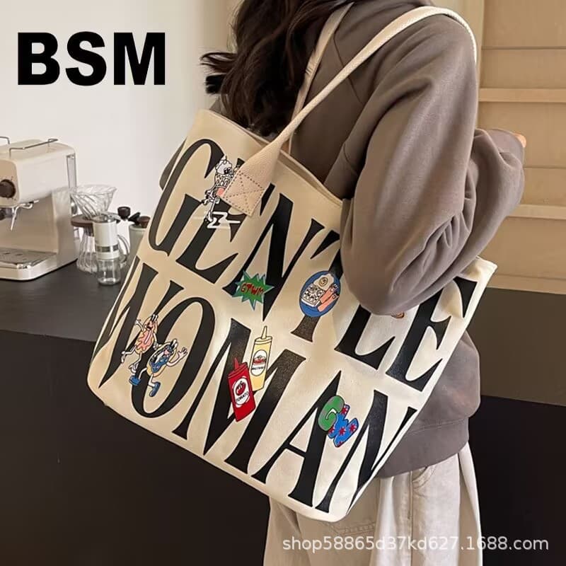 Autumn and winter large-capacity bucket bag for women 2025 new niche comic canvas tote bag college student shoulder tote bag