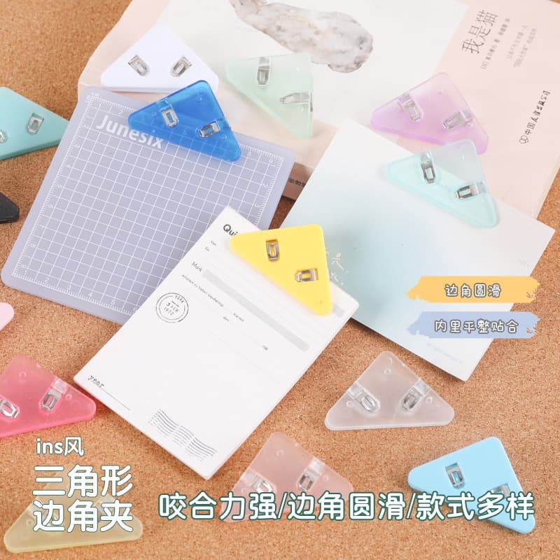 Multi-functional acrylic triangle clips for preventing document curling, office file and bill organization in journals and planners.