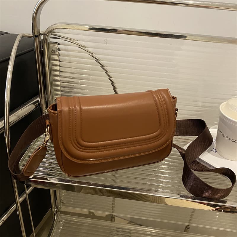 2025 New Saddle Bag Women's Bag Niche Design Horseshoe Bag Solid Color Flip Impression Fashion Women's Crossbody Bag