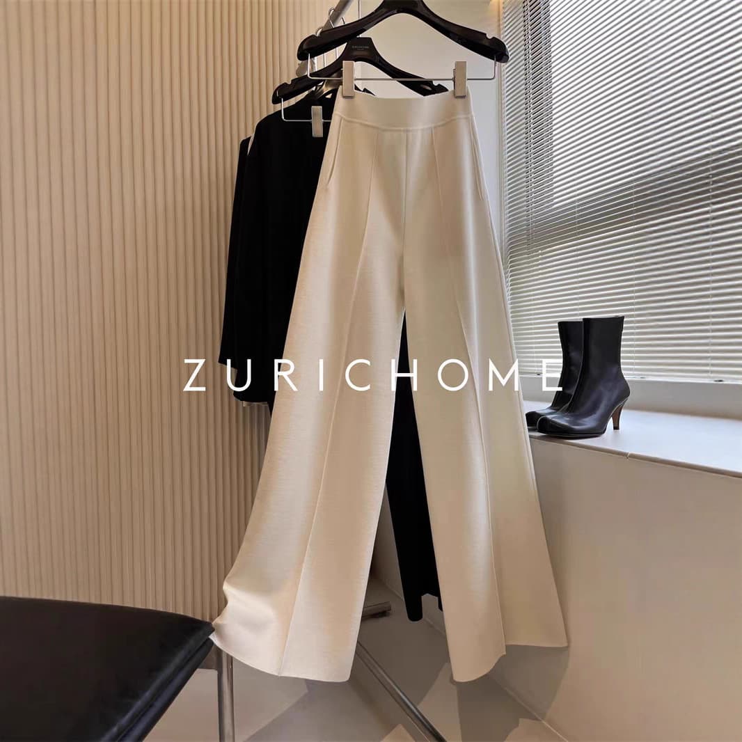 High-quality loose-fit black knitted wide-leg pants with excellent drape, made from high-density wool for a relaxed, elongated silhouette.