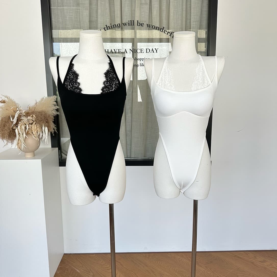 Vertical ribbed knit cami top with removable padded cups and integrated halter neck strap in a one-piece cut