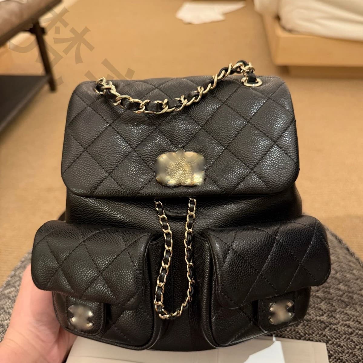 Chanel Duma frog bag, calfskin quilted backpack with multiple pockets and chain strap.