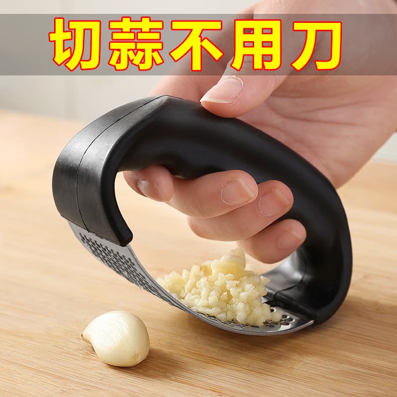 Stainless steel manual ring garlic press, garlic paste maker, and home kitchen garlic mincing tool.
