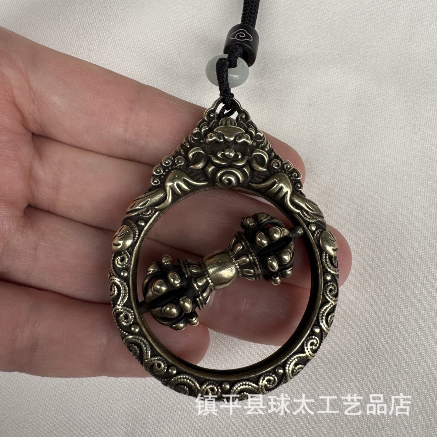 Nepalese-style brass two-tone taotie nine-pronged vajra pendant with rotating center for good fortune.
