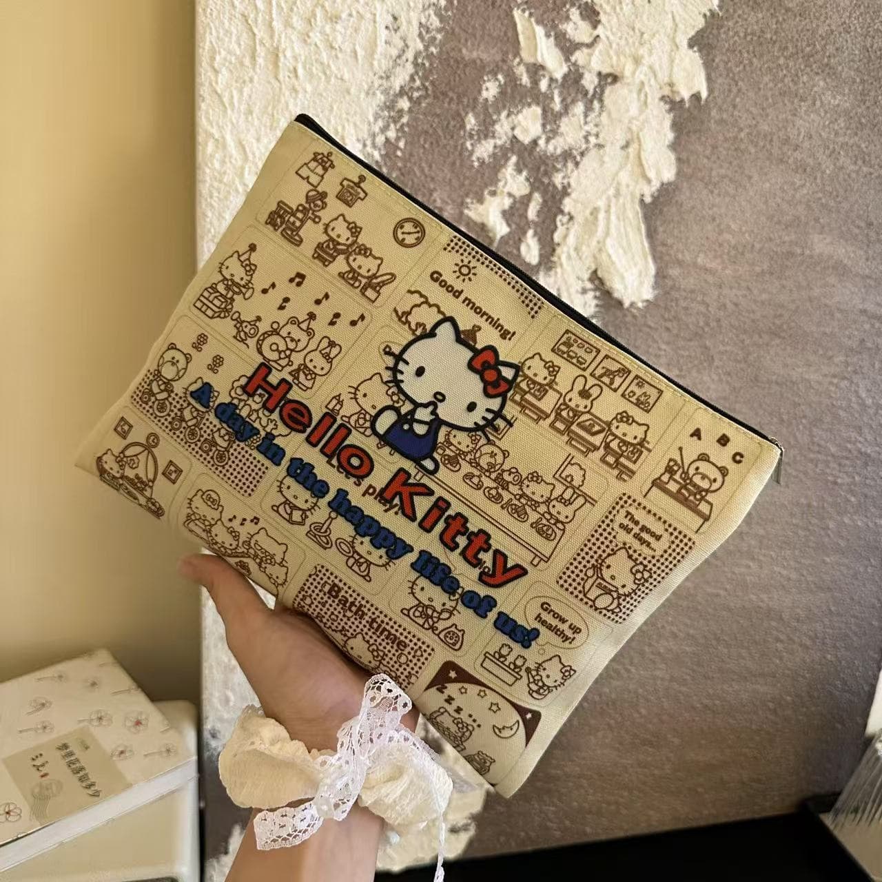 Newspaper Hello Kitty clutch, a stylish and trendy niche bag perfect for outings, Instagram-worthy storage, and student makeup.