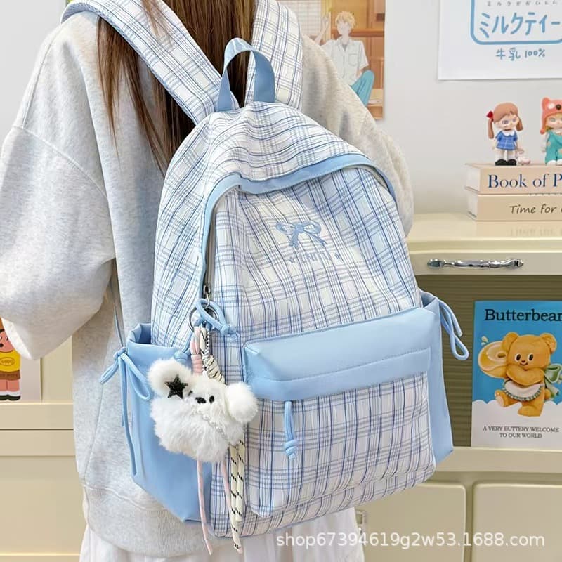 Korean style plaid backpack for middle school girls with large capacity and good looks 2026 new girly style campus backpack