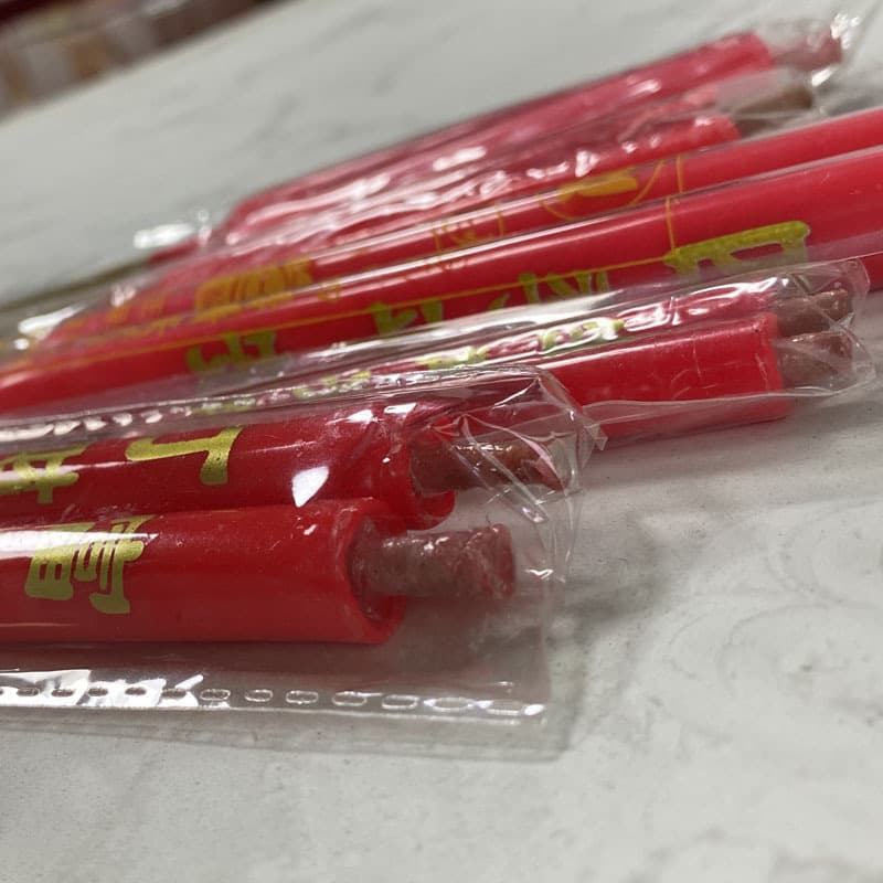 Bamboo stick candles with inscriptions, paired candles for Buddha worship and deity veneration.