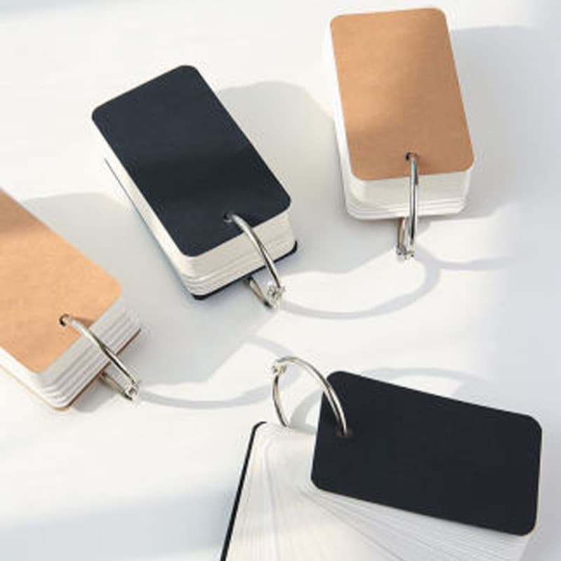 Blank flashcards on white cardstock, portable for memorizing English vocabulary words, linked memory cards, handwritten format.