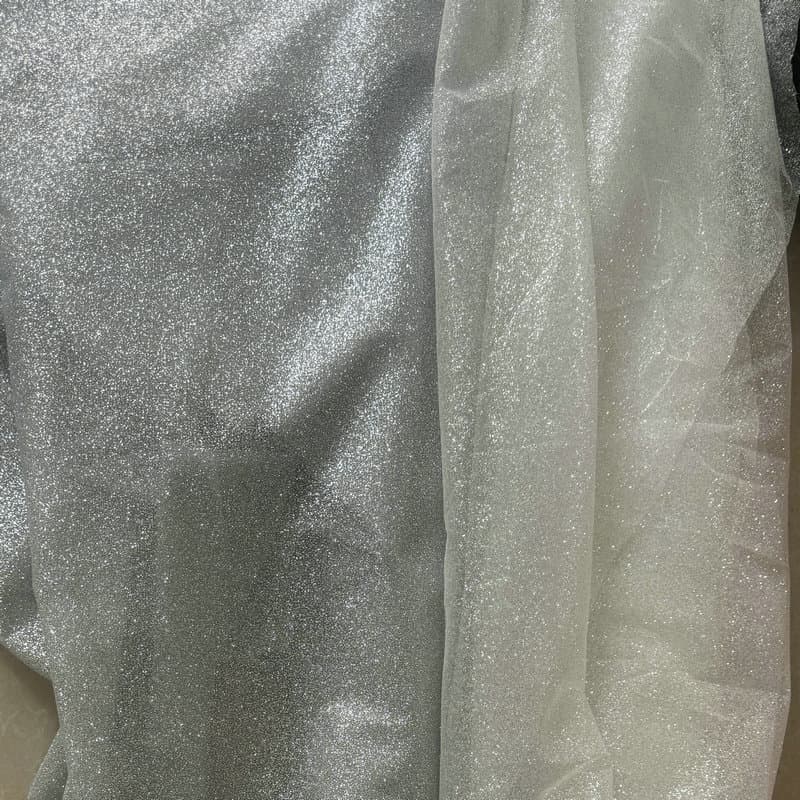 Tulle backdrop scene setup with shimmering mesh tulle, designer fabric for wedding dresses and photography background cloth
