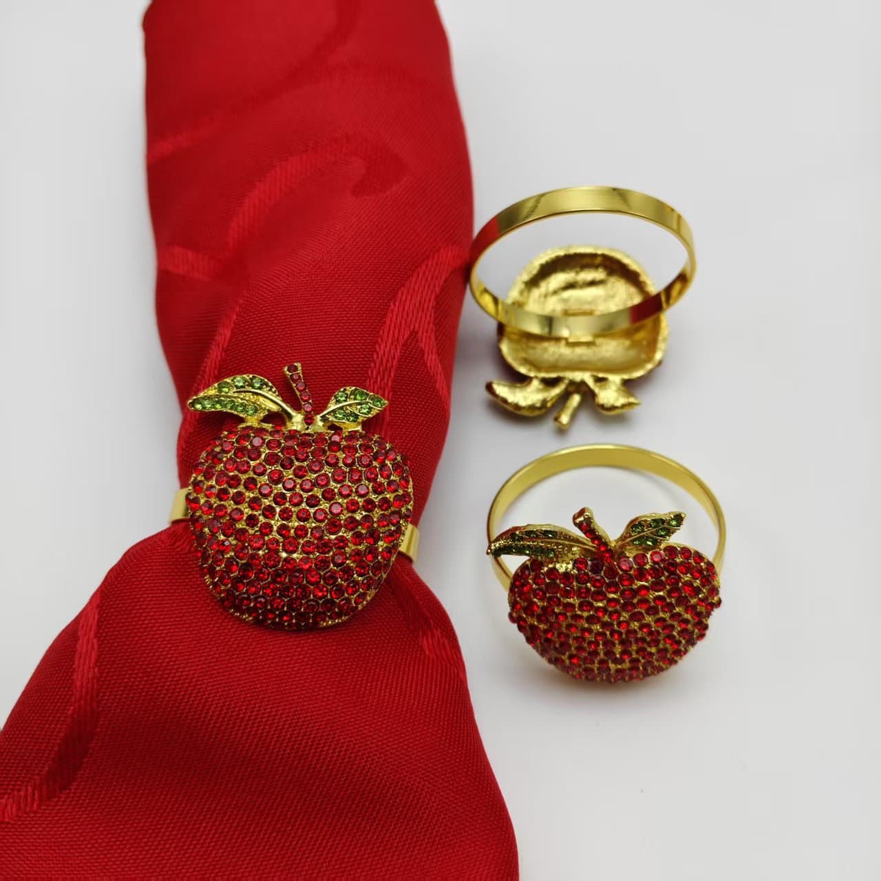 A high-end, luxurious, and auspiciously decorated napkin ring with rhinestone-encrusted apple and fruit design for Christmas Eve, symbolizing good fortune and peace.