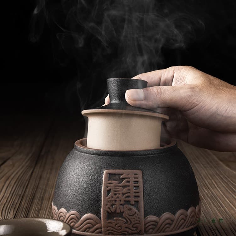 Home ceramic wine warmer set with "abundance every year" motif, vintage-style heating pot and white liquor cups.