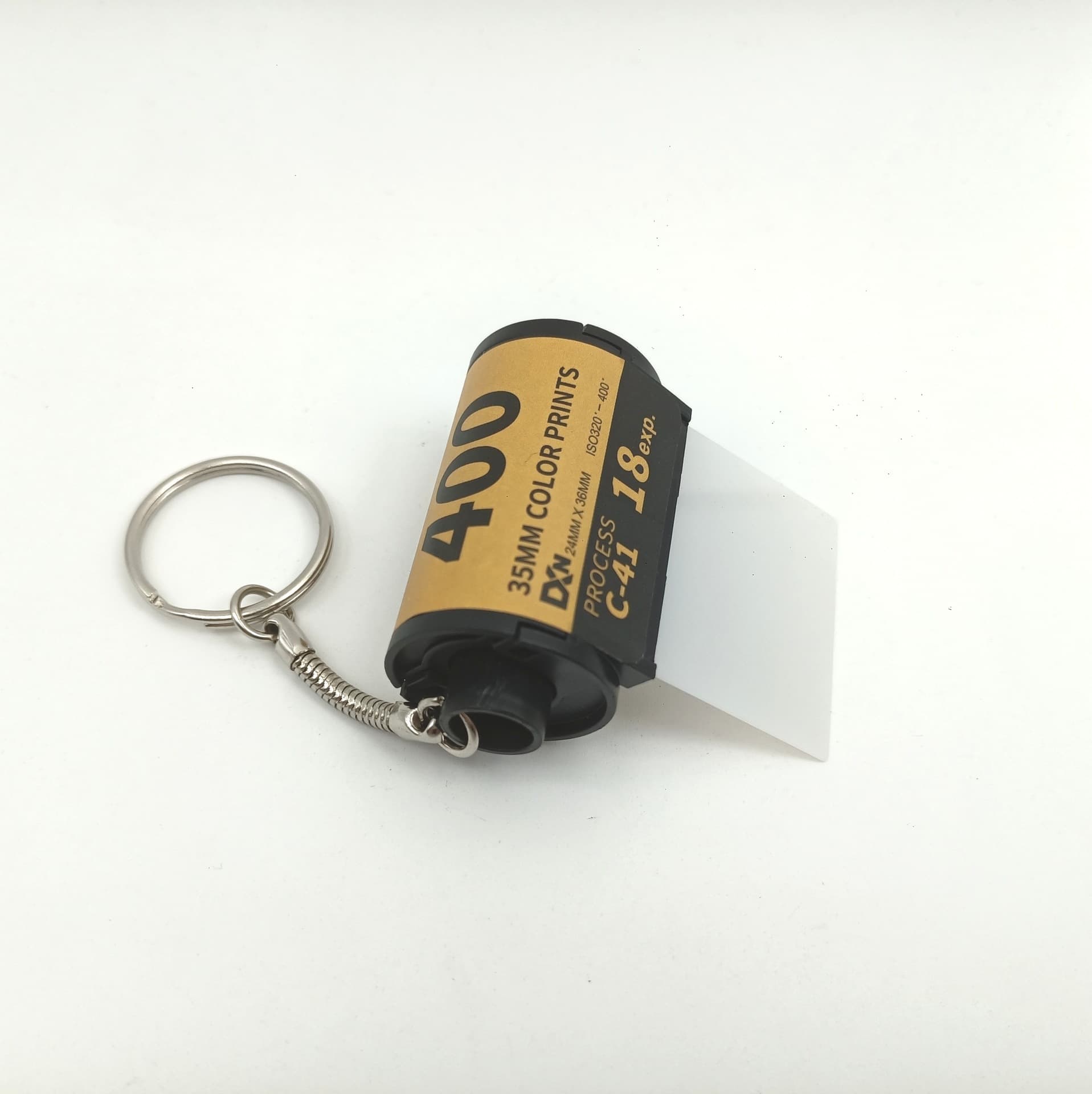 Film album cassette assembly includes velvet, punched film leader, stickers, 135 film, 35mm snake chain keychain