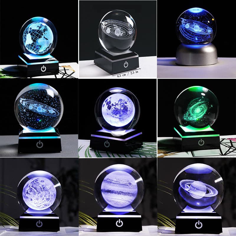 Crystal ball ornaments with internal carvings of stars, moon, solar system, and celestial bodies, perfect for home decoration.