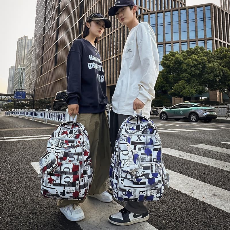 Korean version of fashionable graffiti newspaper backpack 2026 new ins couple school bag large capacity nylon cloth backpack for women
