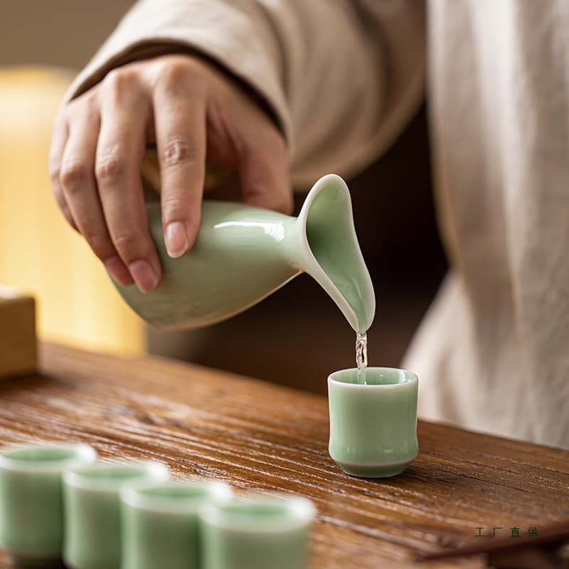 Double-spouted ceramic home decanter set with small antique-style cups, including liquor cups and shot glasses